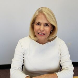 Headshot of Carol Martin smiling with a plain white background.